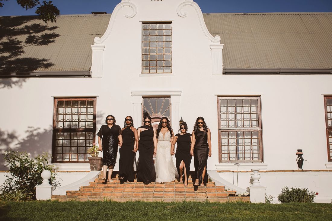 Bridal party on the steps of the Cape Dutch manor at Klein Parys Vineyards