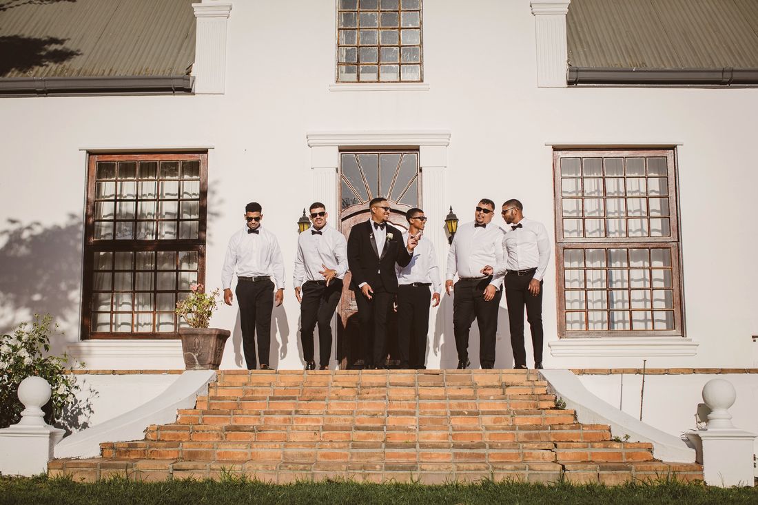 Groomsmen outside the Cape Dutch manor house at Klein Parys Vineyards