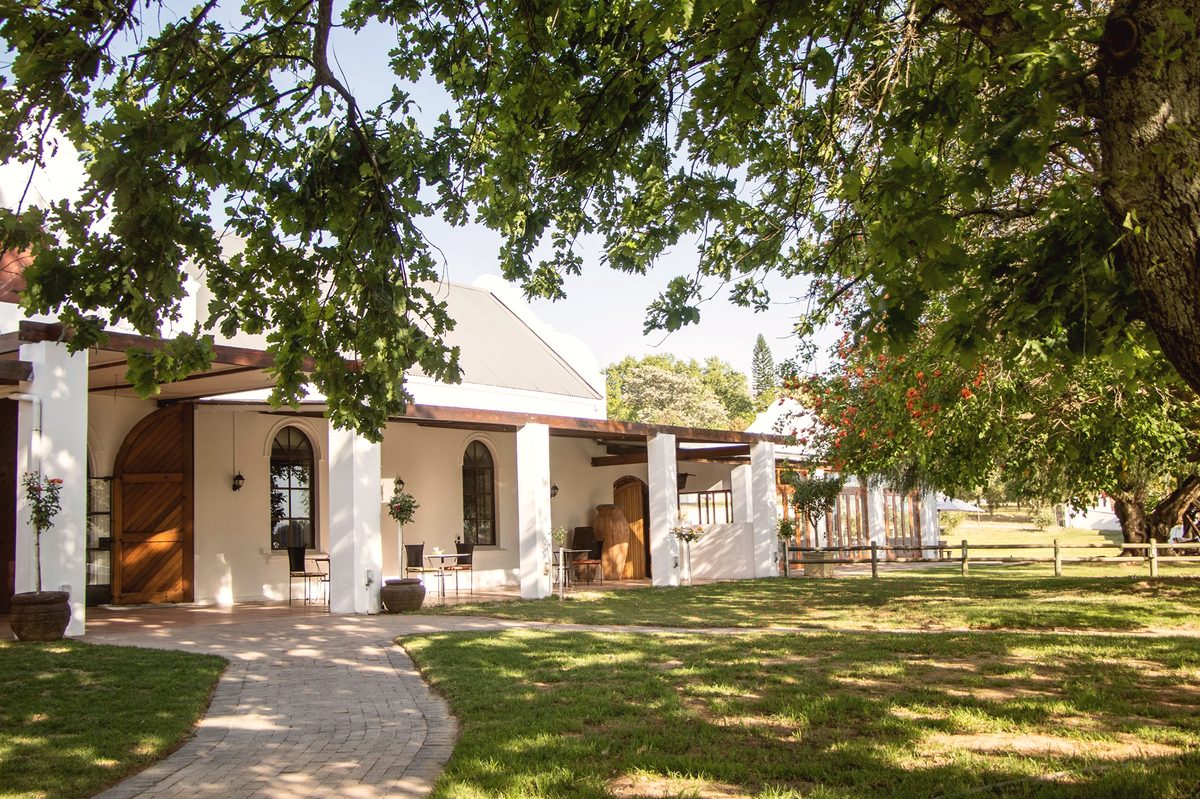 Oppiestoep Restaurant at Klein Parys Vineyards Paarl — interior with oak trees and vineyard views